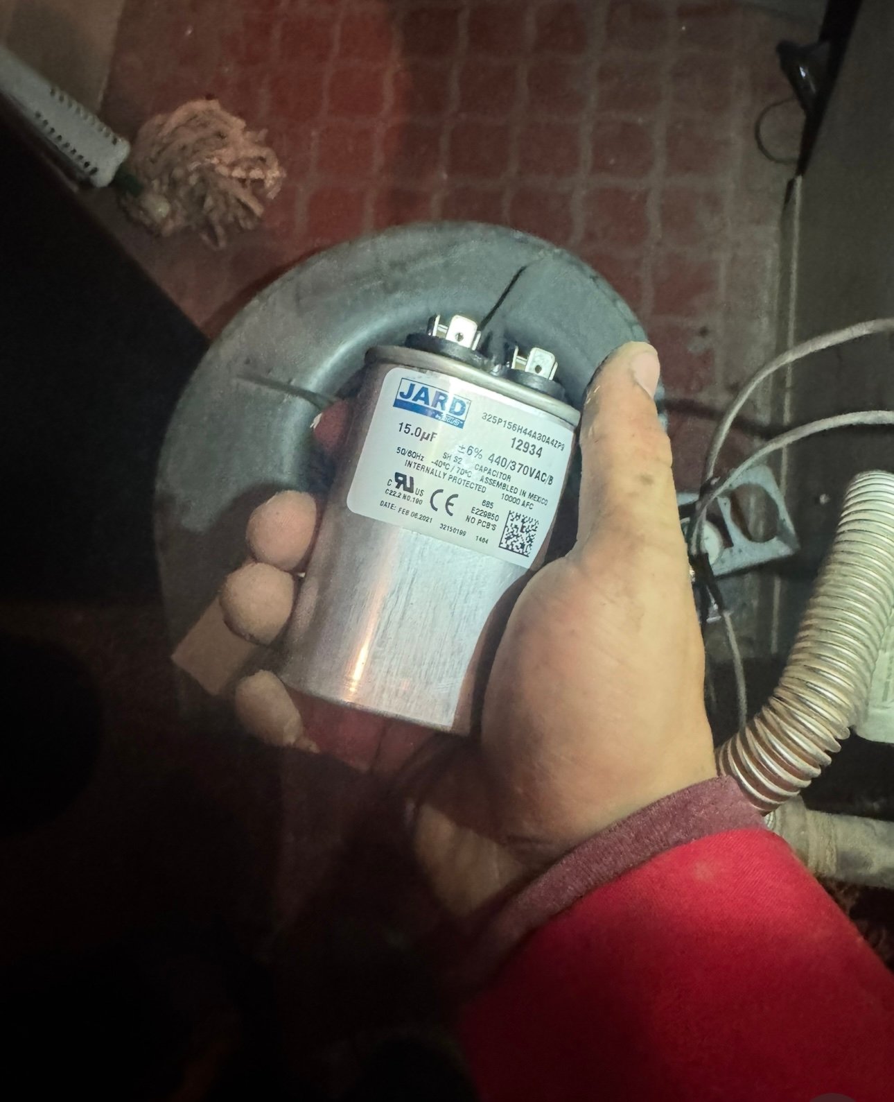 Technician replacing capacitor on indoor fan of AC system in Tucson