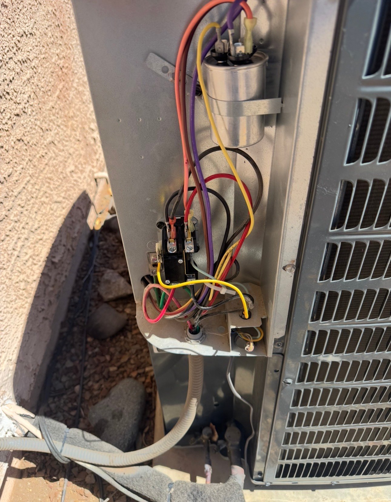 Inside the electrical compartment of an AC condenser during tune-up service