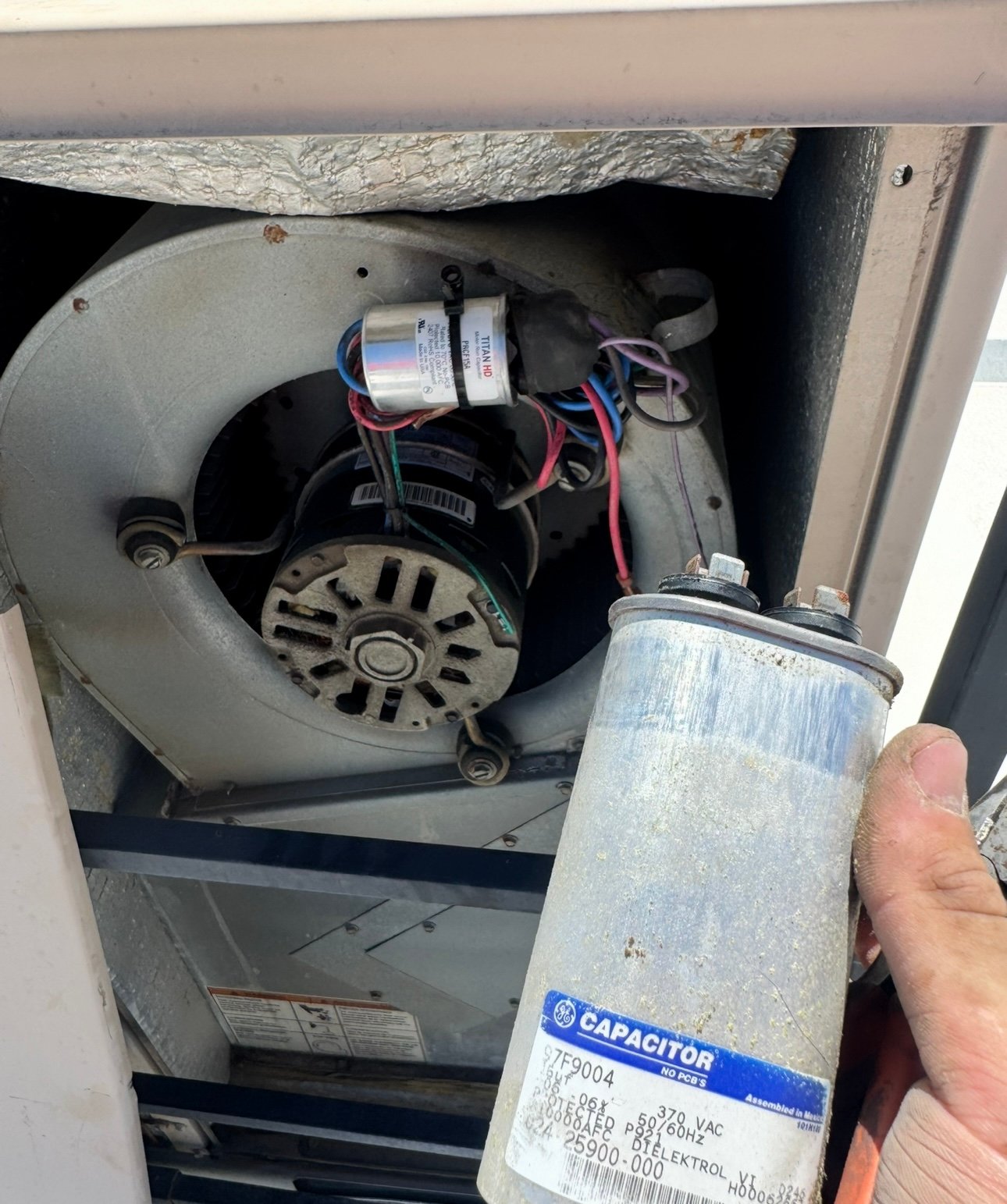 Blower motor capacitor replaced during HVAC repair in Tucson.