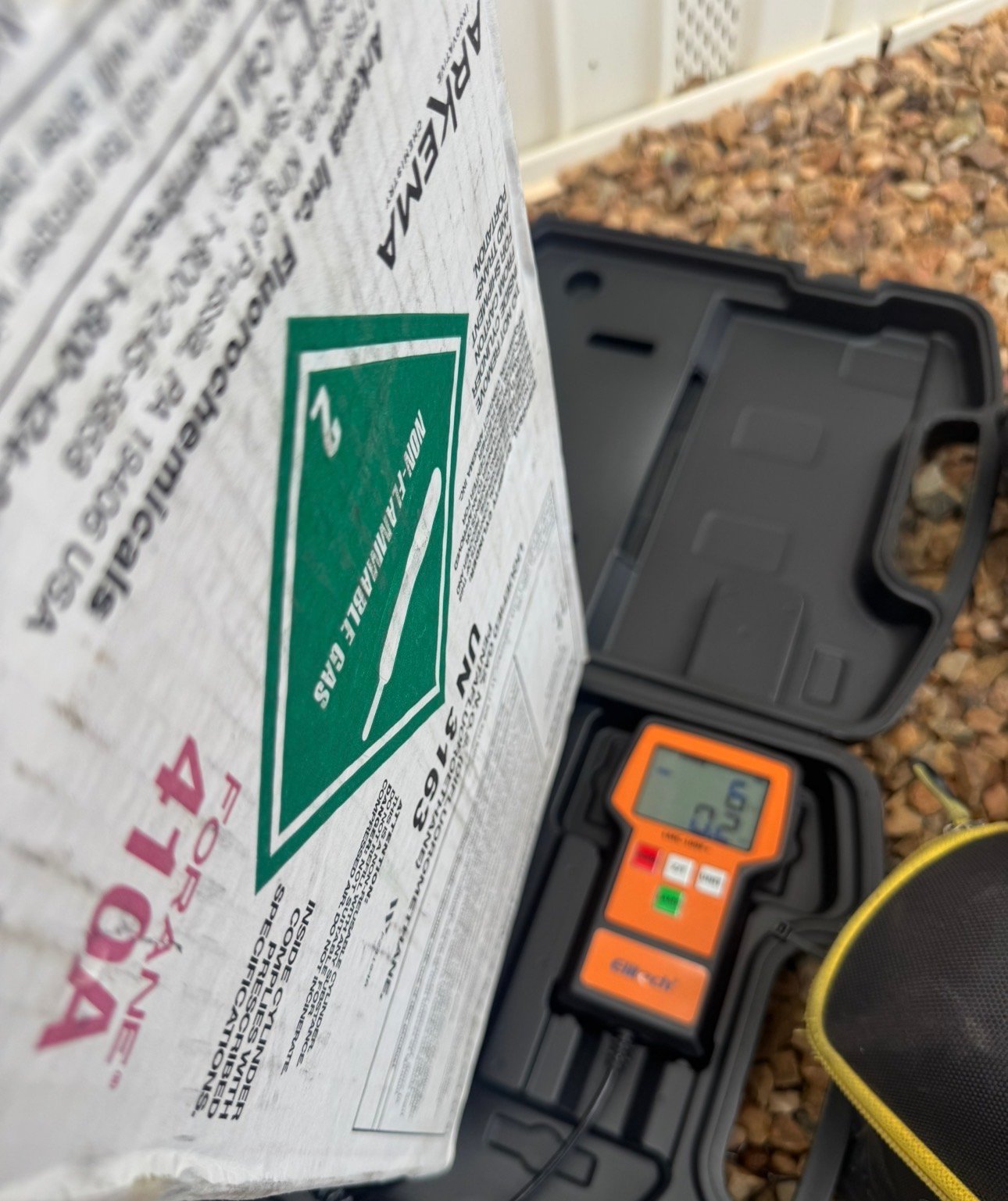Technician weighing in refrigerant during AC service in Sahuarita, AZ