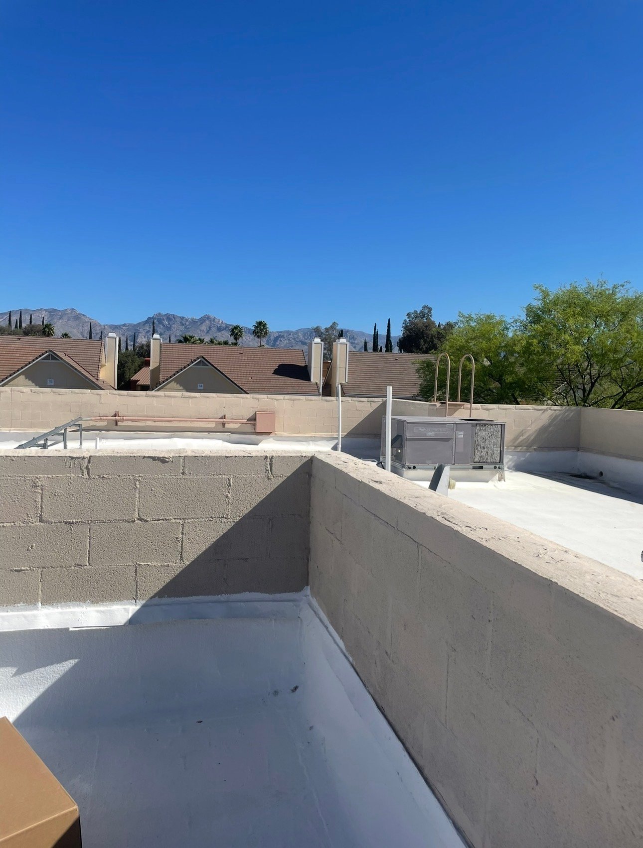 Commercial HVAC unit on a rooftop viewed from a distance
