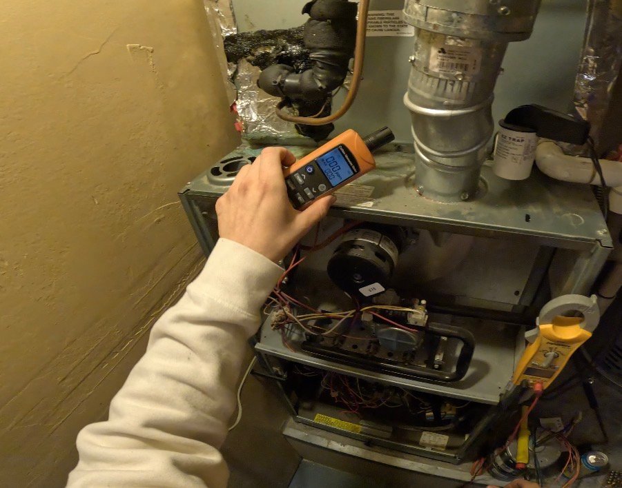 Technician performing carbon monoxide reading on furnace in Sierra Vista and Tucson