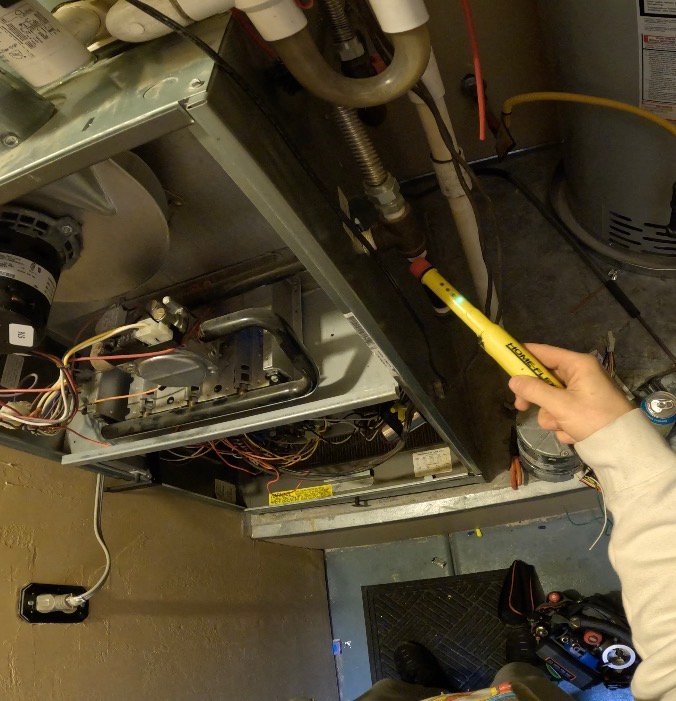 Technician performing gas leak detection for HVAC system in Oro Valley
