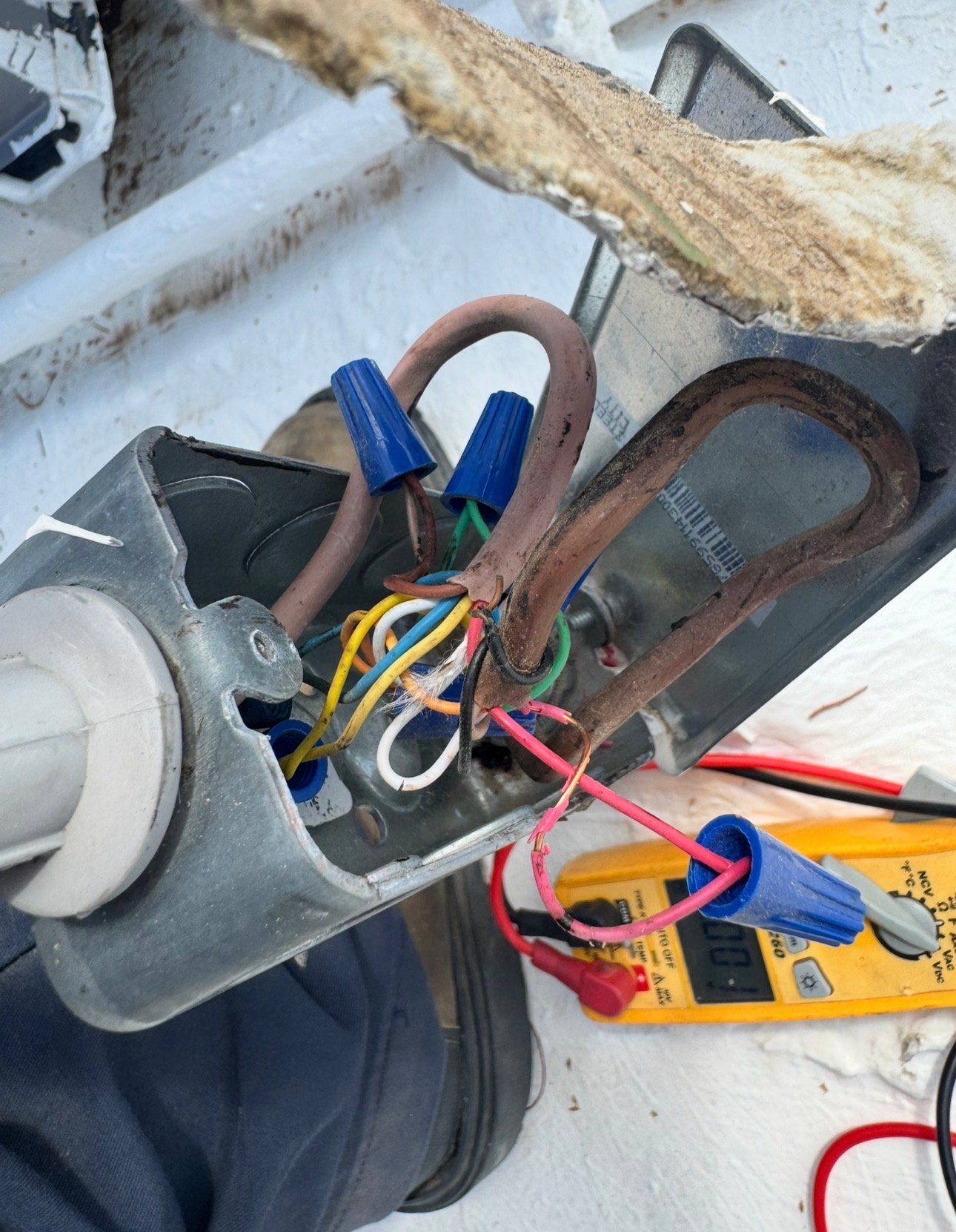 Technician locating low voltage short during HVAC maintenance in Tucson