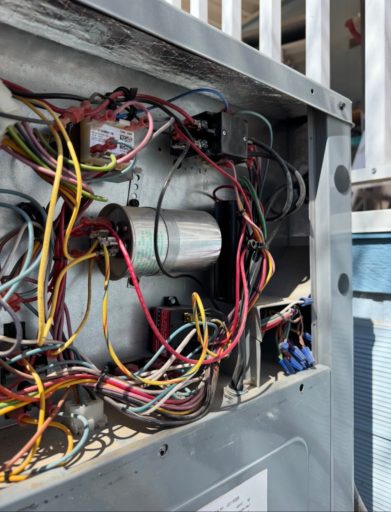 Electrical components in a packaged AC unit during maintenance in Oro Valley.