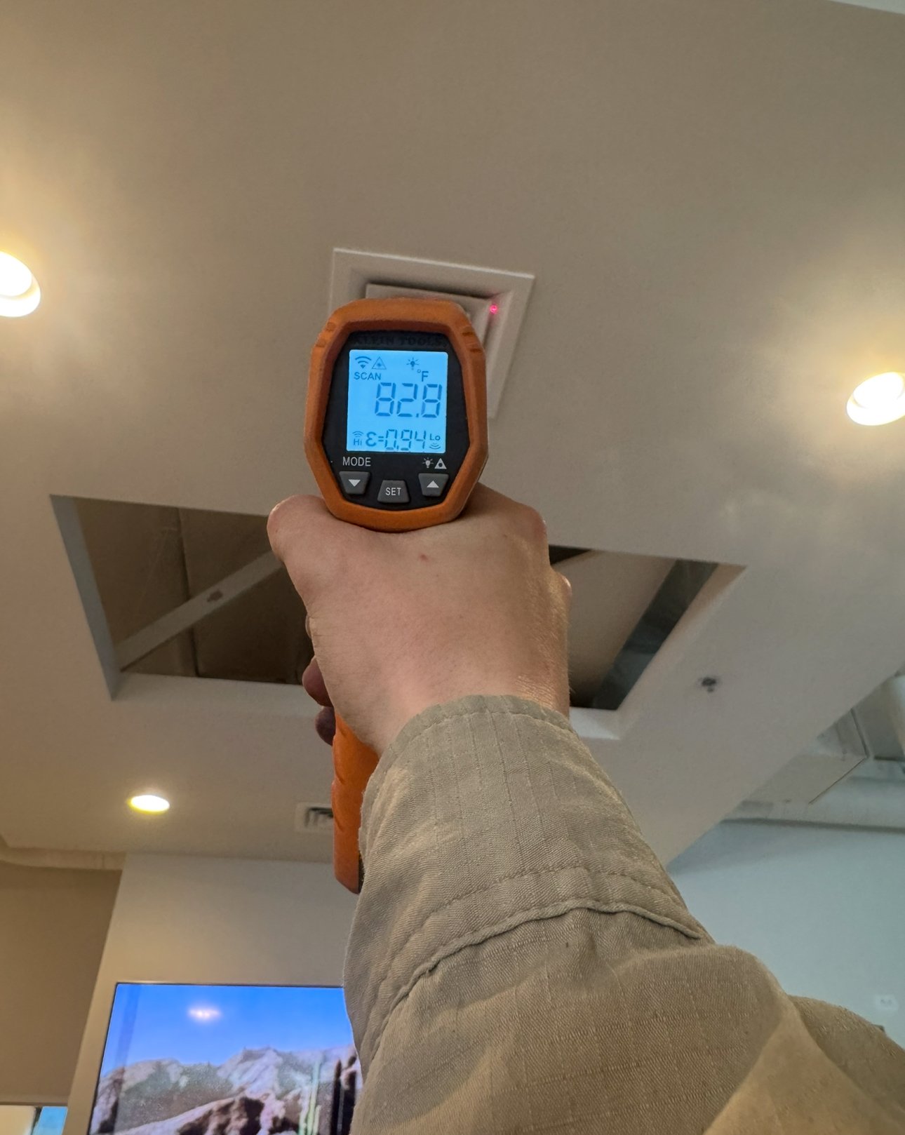 Technician measuring supply air temperature during AC inspection in Marana.