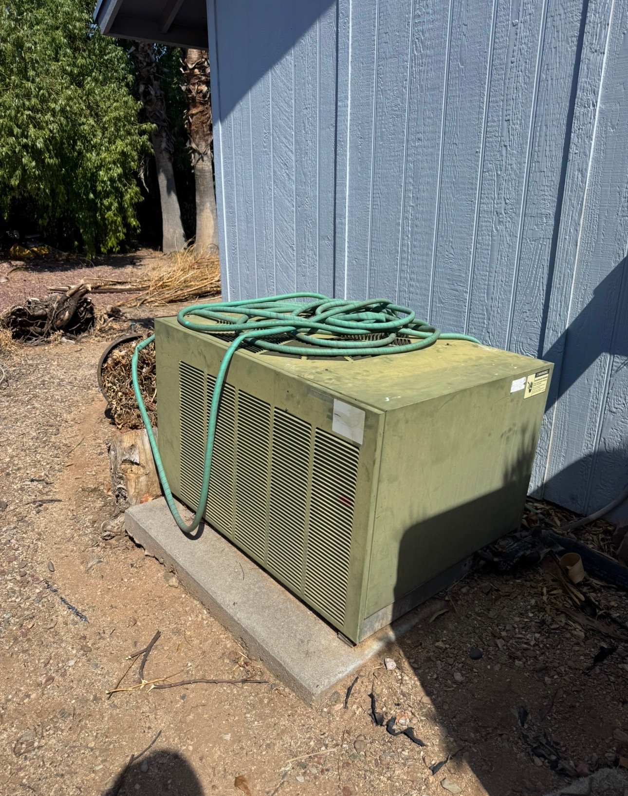 Older outdoor AC condenser showing wear during service in Vail, AZ