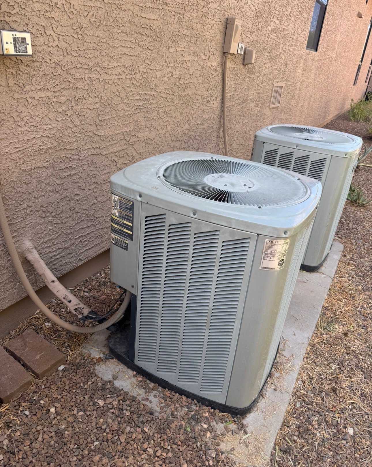 Two outdoor AC condensers providing cooling for a South Tucson home