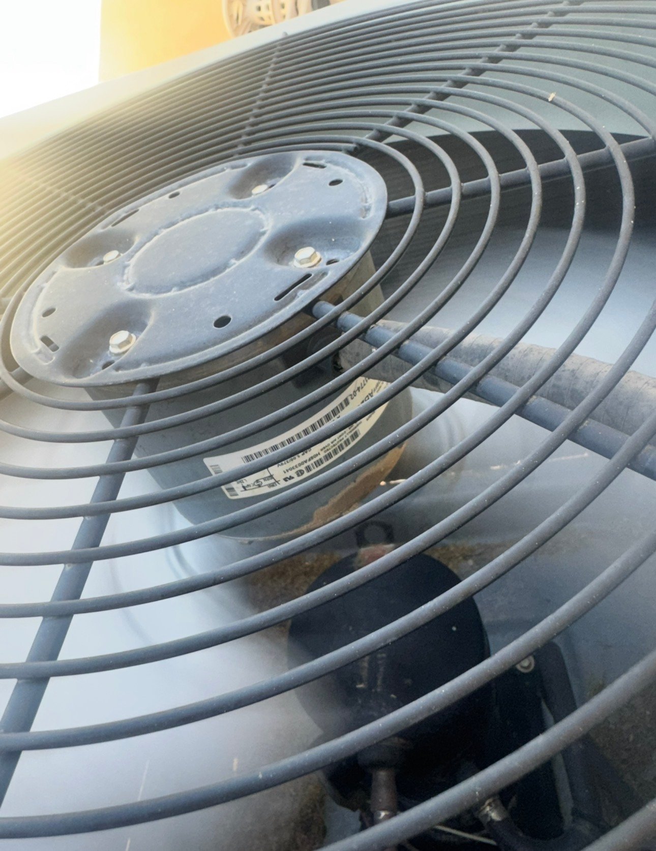 Outdoor fan motor being serviced during AC repair in Casas Adobes, AZ