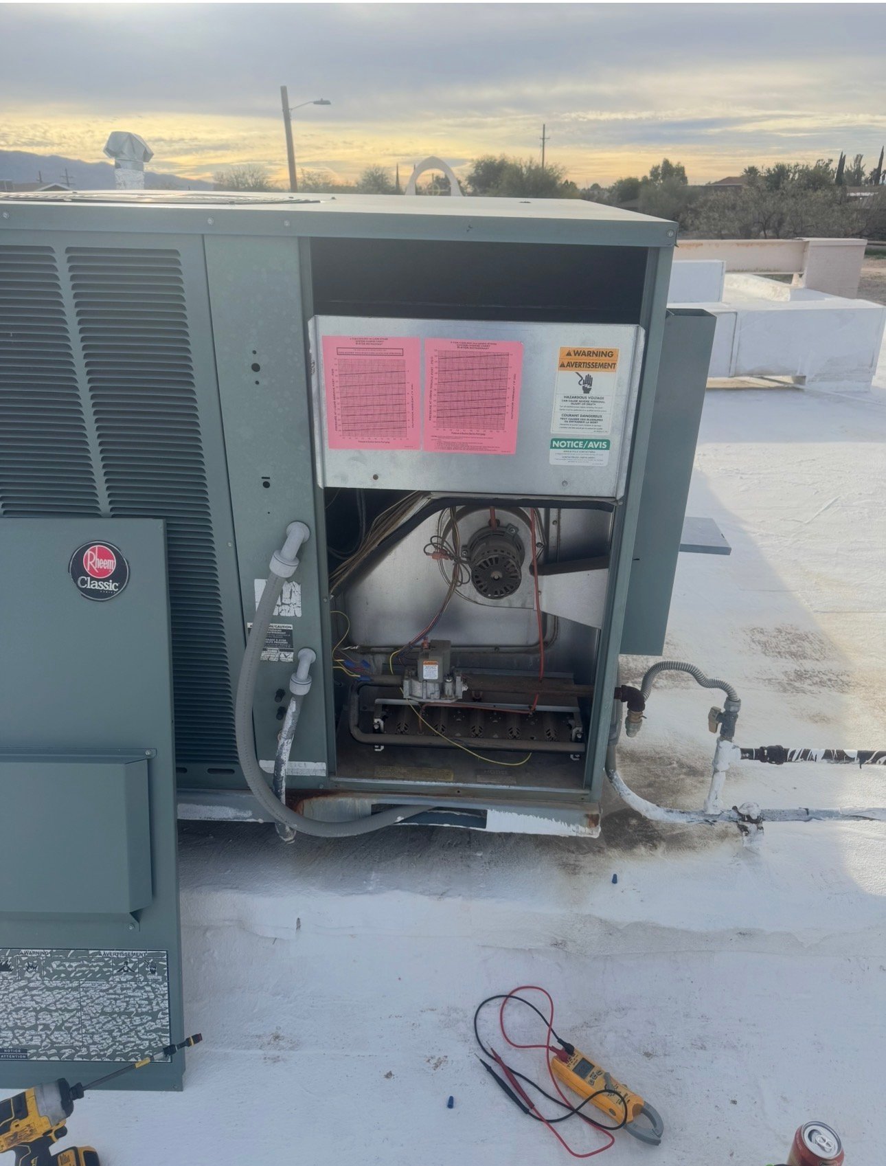 Package unit with electrical compartment open during AC repair in Avra Valley, AZ