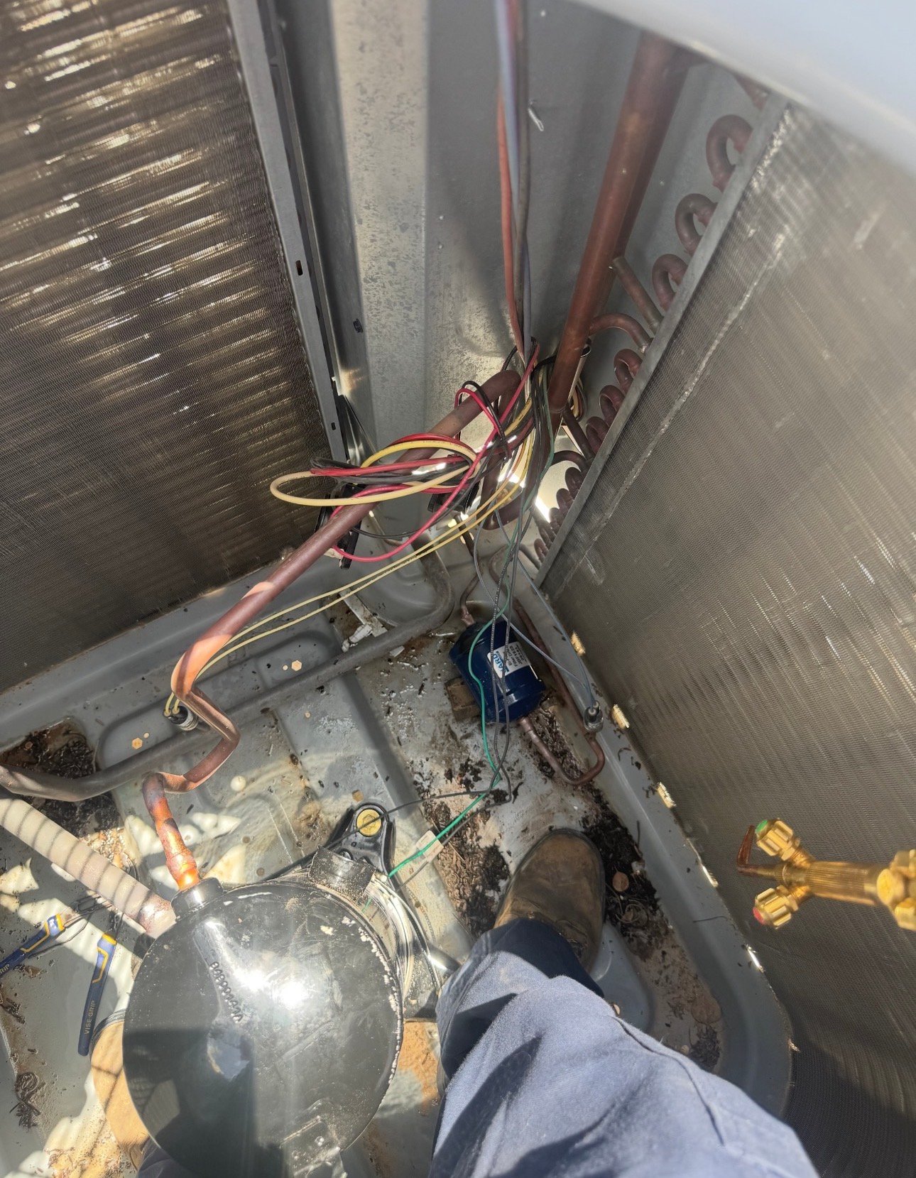 Technician performing a compressor replacement on an AC system in Summit, AZ