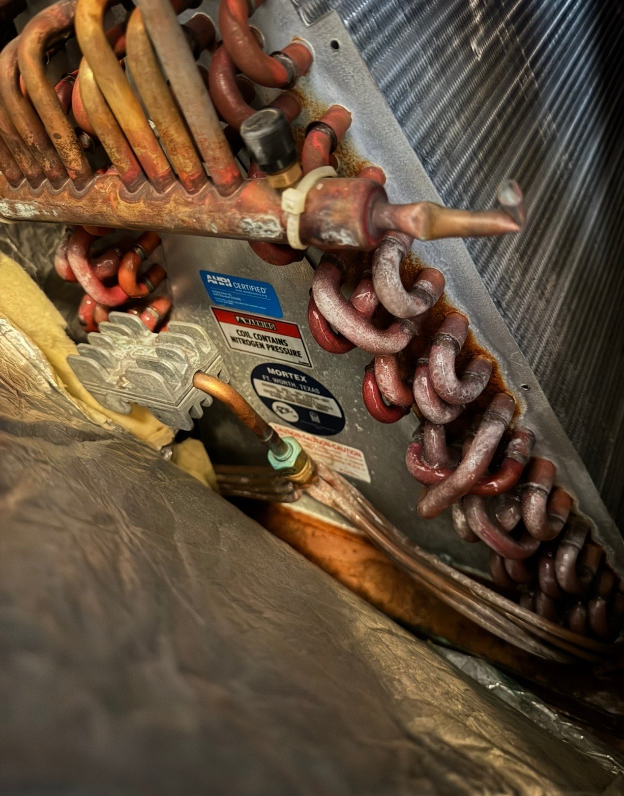 Evaporator coil inside an air conditioning system during service in Valencia West, AZ
